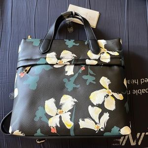 A Crossbody bag/ backpack that is black with floral print
